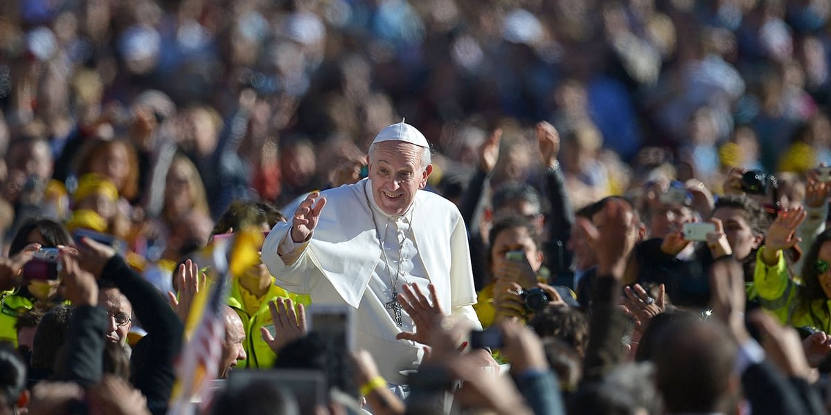 Pope Francis salutes the crowd as he arrives for his general audience in St Peters square at the Vatican on November 6, 2013. — AFP