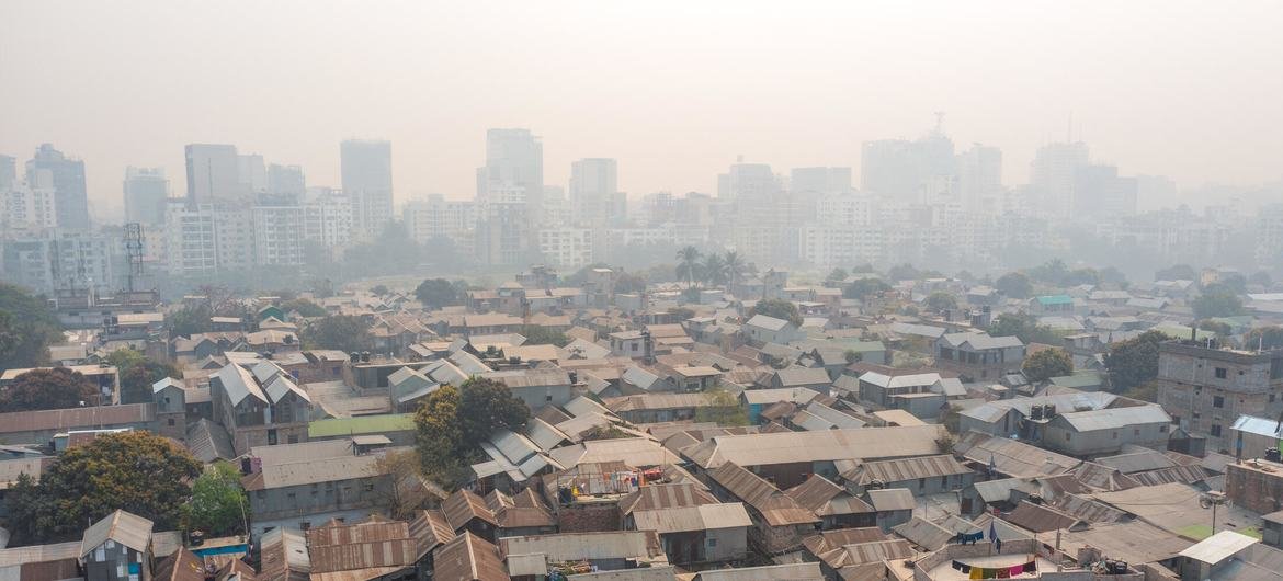 In Dhaka, stark inequality is laid bare as informal settlements sprawl in the foreground, shadowed by rising high-rises in the distance. In Dhaka, stark inequality is laid bare as informal settlements sprawl in the foreground, shadowed by rising high-rises in the distance.
