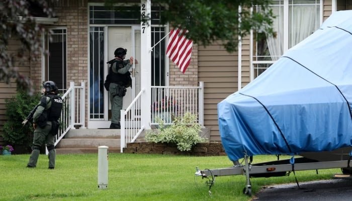 Officers canvas the neighbourhood after what police said was a targeted shooting in the area around Edinburgh Golf Course in the Minneapolis suburb of Brooklyn Park, Minnesota, US June 14, 2025. — Reuters