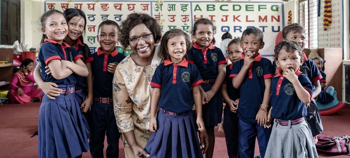 Alice Akunga, UNICEF Representative to Nepal, with a group of young children in a classroom. Alice Akunga, UNICEF Representative to Nepal, with a group of young children in a classroom.